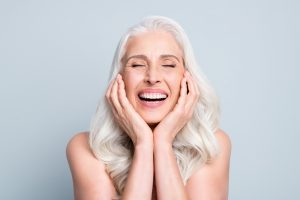 Older women smiling with dental implants